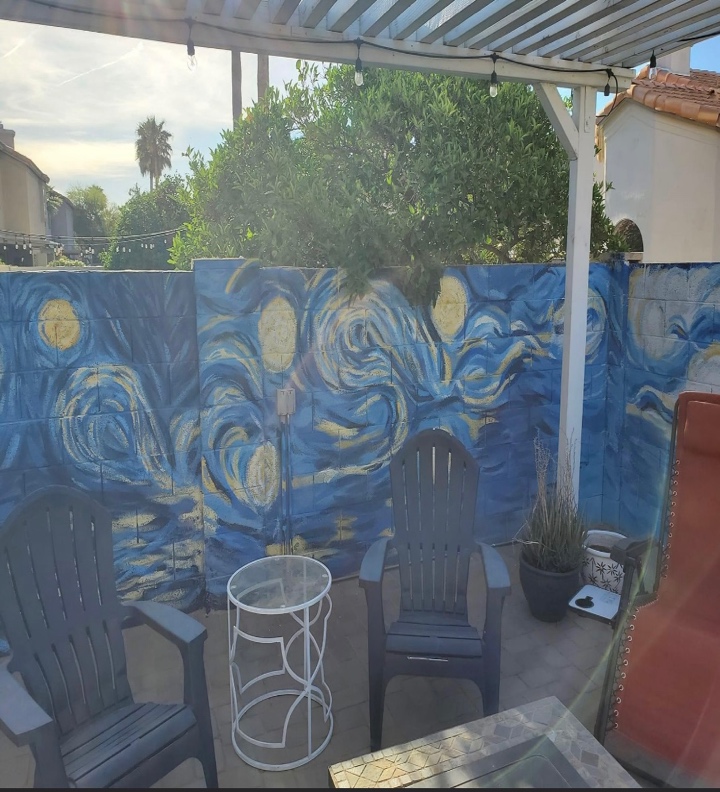 Hand-painted Starry Night mural on a backyard patio wall