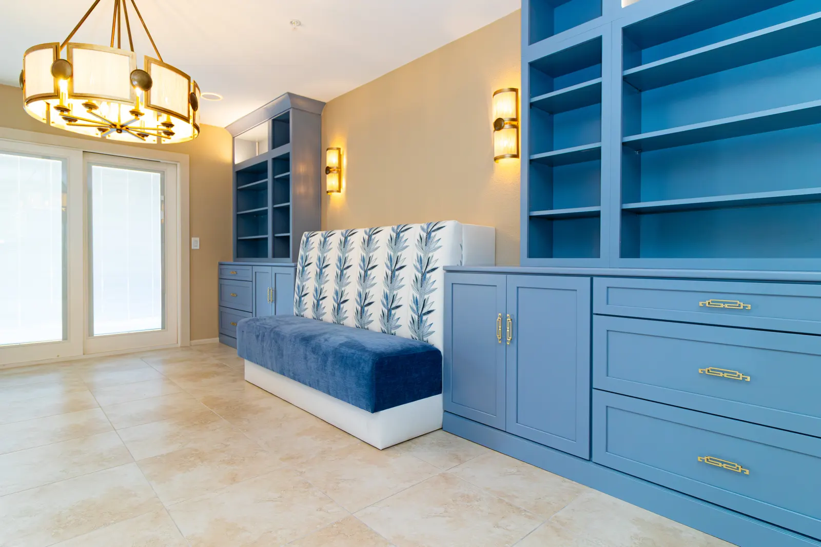 Angled view of the great room built-ins and banquette toward a pair of white French doors